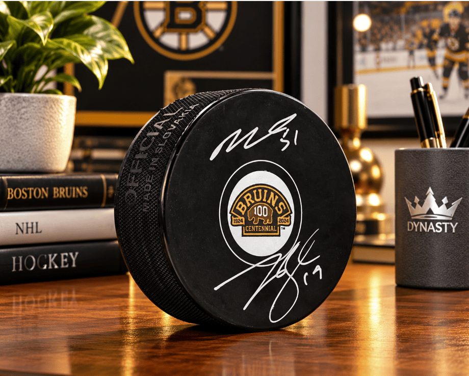 Dynasty Sports & Framing Autographed Pucks Matthew Poitras & Johnny Beecher Autographed Boston Bruins 100th Anniversary Hockey Logo Puck